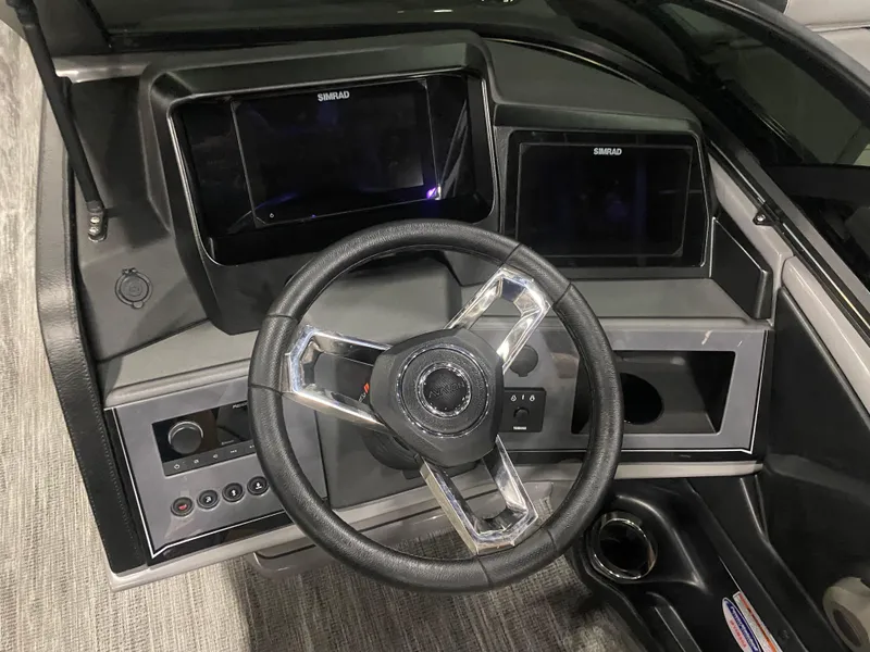 Slide: The Image of 2025 Avalon 2585 Catalina QLW dashboard with steering wheel and dual Simrad displays. - 8