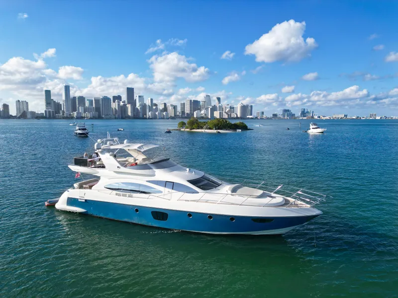 Slide: The Image of 2007 Azimut 68E yacht cruising near city skyline on a sunny day. - 0