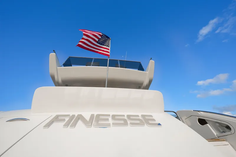Slide: The Image of Azimut 68E 2007 yacht "Finesse" with American flag against blue sky. - 10