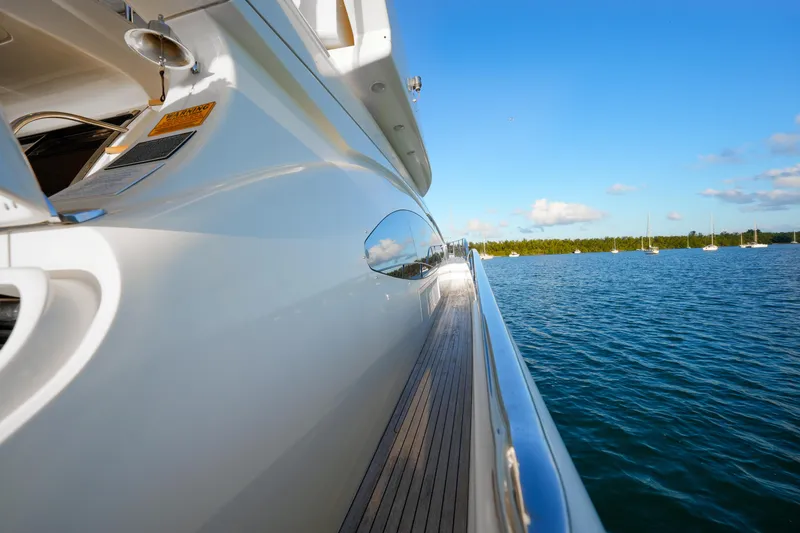 Slide: The Image of Side view of 2007 Azimut 68E yacht on calm blue water. - 11