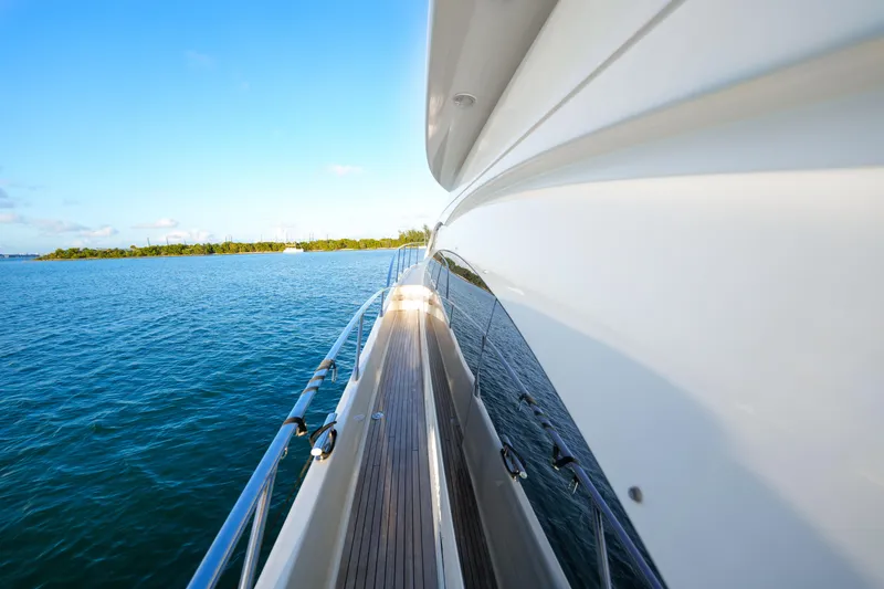 Slide: The Image of Side view of 2007 Azimut 68E yacht cruising on calm blue waters. - 14