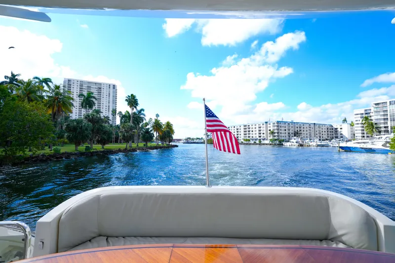 Slide: The Image of View from 2007 Azimut 68E yacht, American flag, waterfront cityscape, clear blue sky. - 15