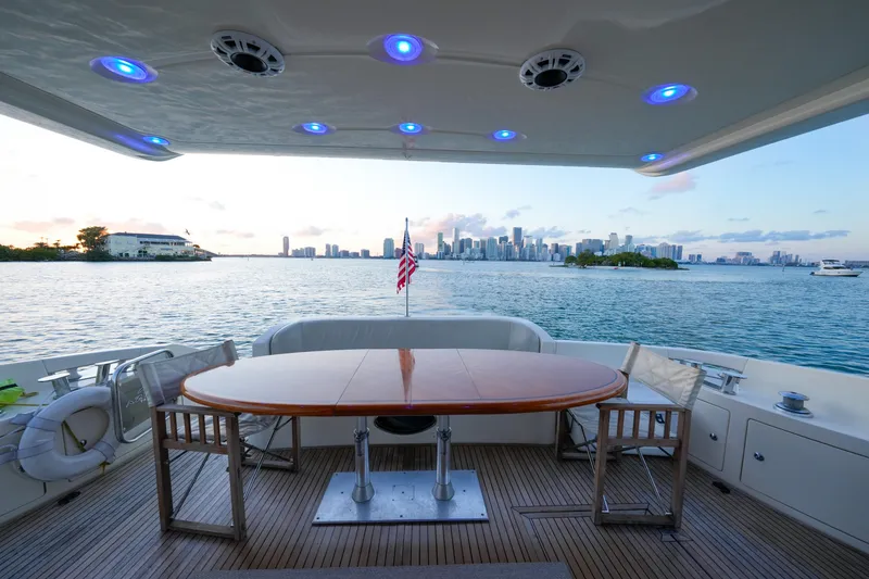 Slide: The Image of Luxury 2007 Azimut 68E yacht deck with city skyline view at sunset. - 21