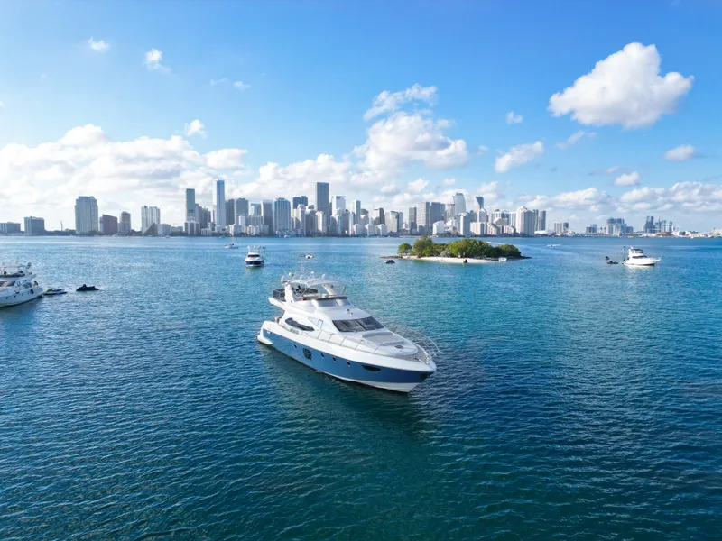 Slide: The Image of Luxurious 2007 Azimut 68E yacht cruising near a city skyline on a sunny day. - 3