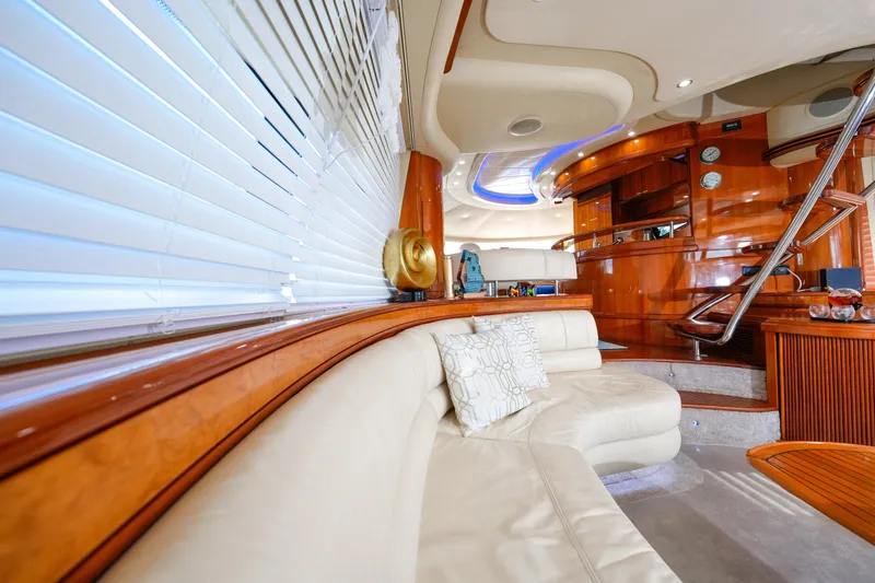 Slide: The Image of Luxurious interior of a 2007 Azimut 68E yacht with elegant wood finishes and plush seating. - 38