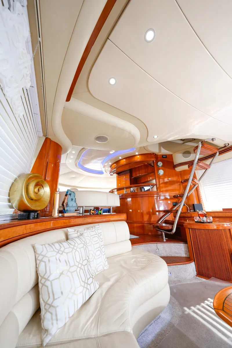 Slide: The Image of Luxurious interior of a 2007 Azimut 68E yacht with elegant wood finishes and plush seating. - 40