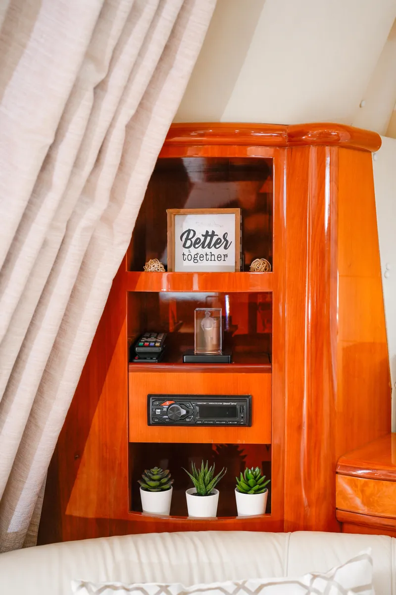 Slide: The Image of Interior of 2007 Azimut 68E yacht with wooden shelves and decor items. - 42