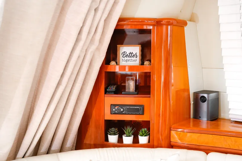 Slide: The Image of Luxurious interior of 2007 Azimut 68E yacht with elegant wooden shelving and decor. - 43