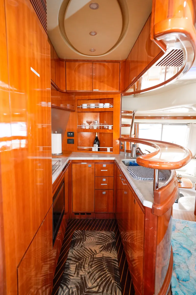 Slide: The Image of Luxurious 2007 Azimut 68E yacht kitchen with sleek wood cabinetry and modern appliances. - 47