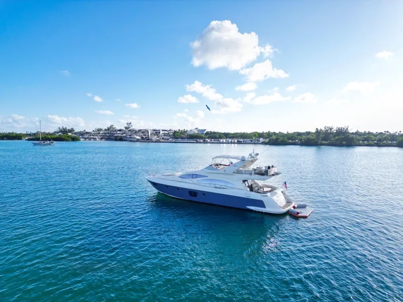 Slide: The Image of 2007 Azimut 68E yacht on serene blue water under a clear sky. - 5