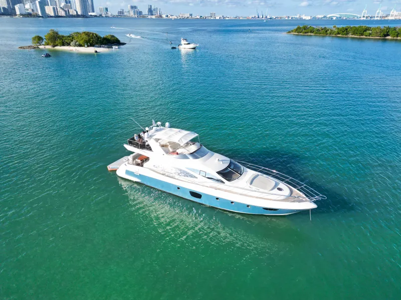 Slide: The Image of Azimut 68E 2007 yacht cruising in clear blue waters near city skyline. - 6