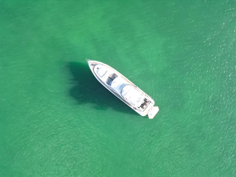 Slide: The Image of Aerial view of 2007 Azimut 68E yacht on clear green water. - 7