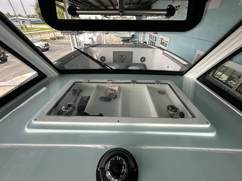 Slide: The Image of 2025 Twin Vee 400 GFX2 CC boat interior, showcasing dashboard and windshield view. - 11