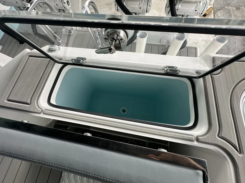 Slide: The Image of Livewell on 2025 Twin Vee 400 GFX2 CC boat, featuring sleek design and rod holders. - 14