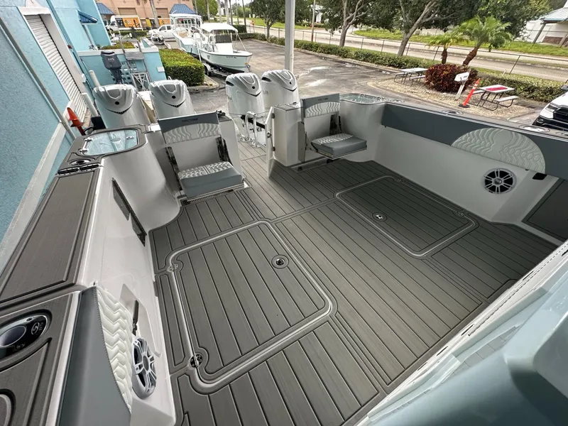 Slide: The Image of 2025 Twin Vee 400 GFX2 CC boat interior with spacious deck and modern seating. - 19