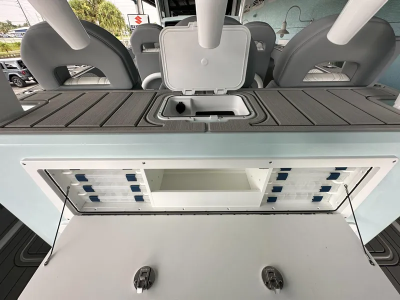 Slide: The Image of 2025 Twin Vee 400 GFX2 CC boat interior with storage compartments and seating. - 23