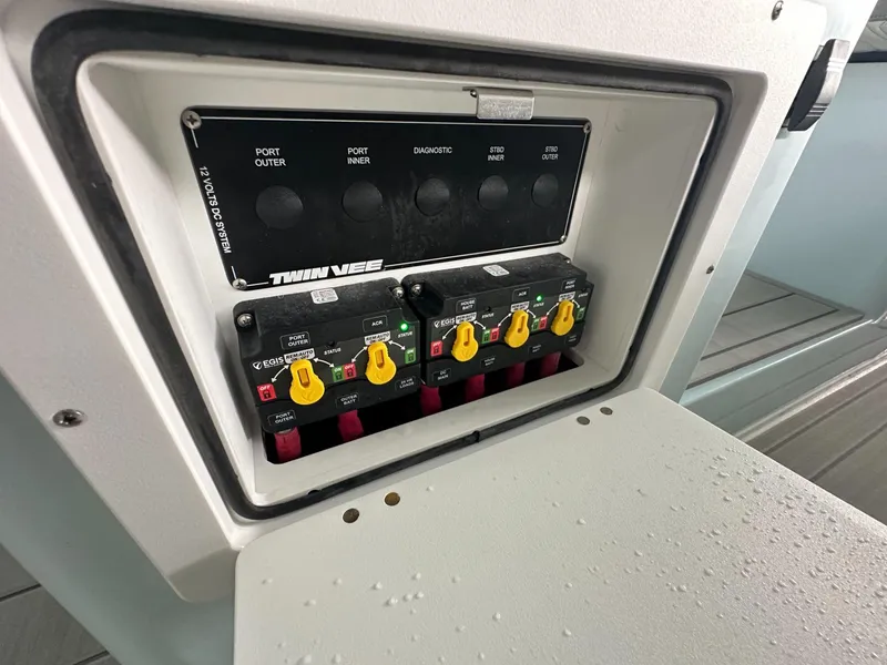 Slide: The Image of Control panel of 2025 Twin Vee 400 GFX2 CC boat with switches and labels. - 27