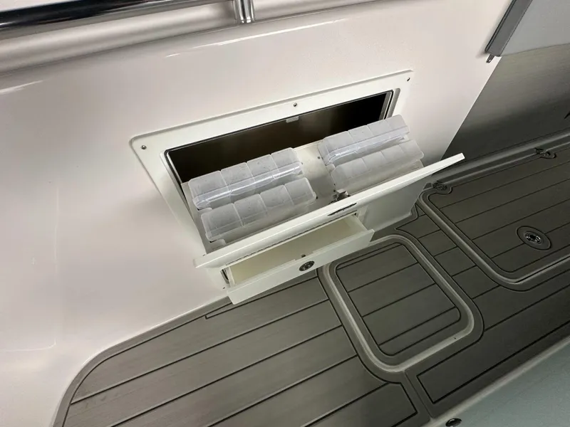 Slide: The Image of 2025 Twin Vee 400 GFX2 CC boat storage compartment with tackle boxes. - 33