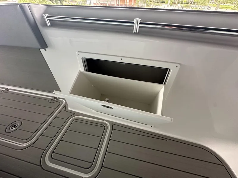 Slide: The Image of 2025 Twin Vee 400 GFX2 CC boat storage compartment with sleek deck design. - 38