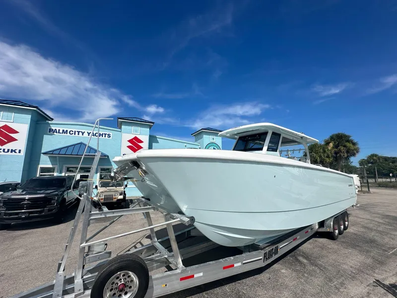 Slide: The Image of 2025 Twin Vee 400 GFX2 CC boat on trailer at Palm City Yachts dealership. - 4