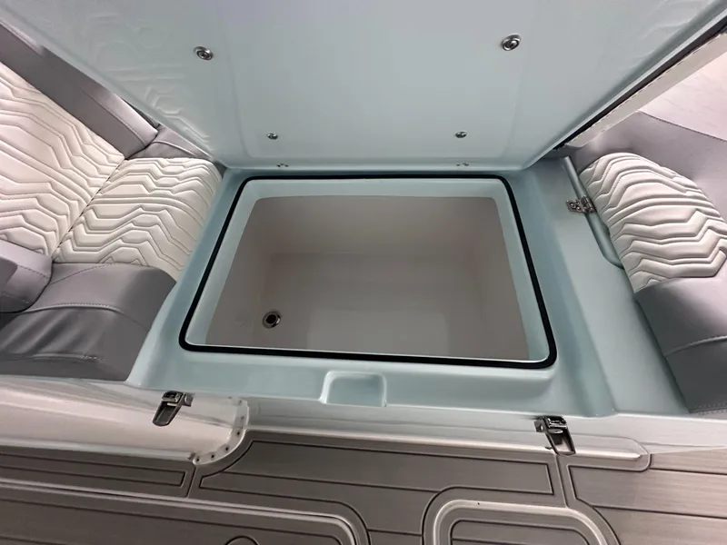 Slide: The Image of 2025 Twin Vee 400 GFX2 CC boat interior with storage compartment and cushioned seating. - 43