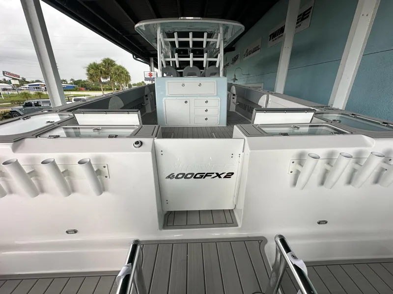 Slide: The Image of 2025 Twin Vee 400 GFX2 CC boat, spacious deck, rod holders, modern design. - 7