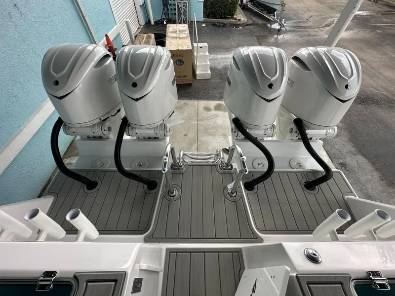 Slide: The Image of 2025 Twin Vee 400 GFX2 CC boat with four powerful outboard engines. - 8