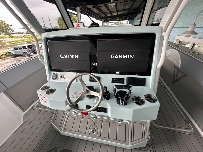 Slide: The Image of 2025 Twin Vee 400 GFX2 CC boat dashboard with dual Garmin displays. - 9