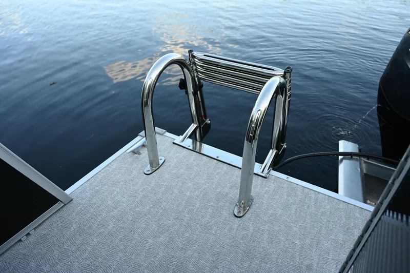 Slide: The Image of 2025 Princecraft Vectra 23 RL boat ladder on water, showcasing sleek design. - 10