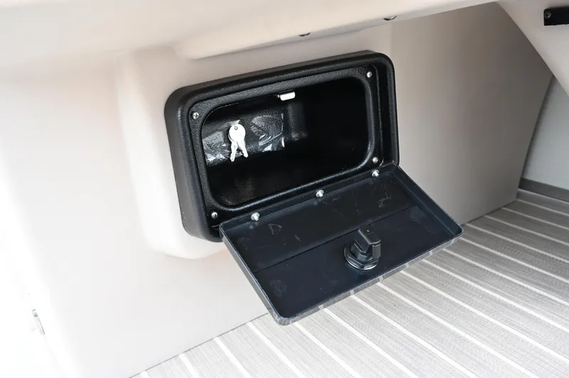 Slide: The Image of Open storage compartment with keys inside on 2025 Princecraft Vectra 23 RL boat. - 5