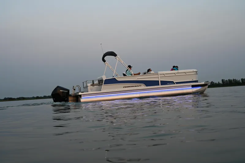 Slide: The Image of 2025 Princecraft Vectra 23 RL pontoon boat on calm water at dusk. - 6