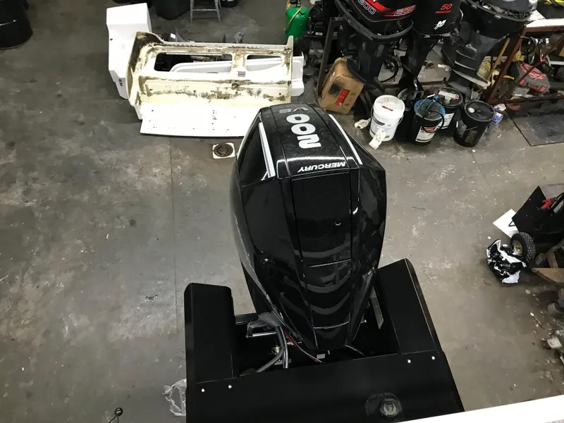 Slide: The Image of 2025 Ranger Reata 223FC boat interior with beige seating and modern dashboard in a garage setting. - 11