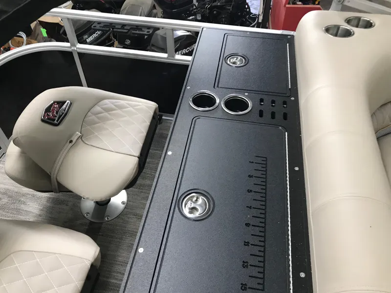 Slide: The Image of 2025 Ranger Reata 223FC boat seats with quilted design and logo on carpeted deck. - 14