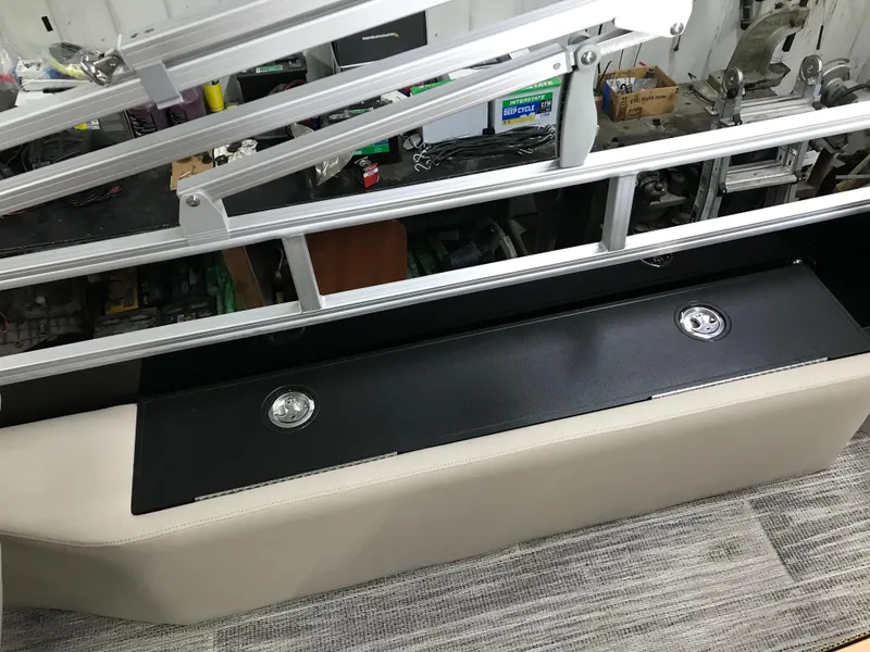 Slide: The Image of 2025 Ranger Reata 223FC boat interior with beige seating and wood-style flooring. - 18