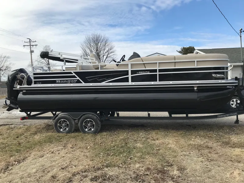 Slide: The Image of 2025 Ranger Reata 223FC pontoon boat in a garage setting. - 4