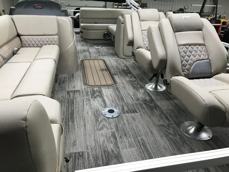 Slide: The Image of 2025 Ranger Reata 223FC boat interior with beige seating and wood-style flooring. - 8
