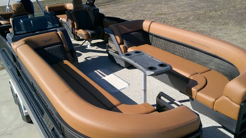 Slide: The Image of 2025 Bennington MFB 26 boat interior with luxurious tan seating and a central table. - 4