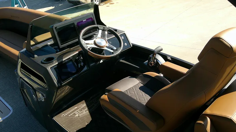 Slide: The Image of 2025 Bennington MFB 26 boat interior with modern steering and brown seating. - 7