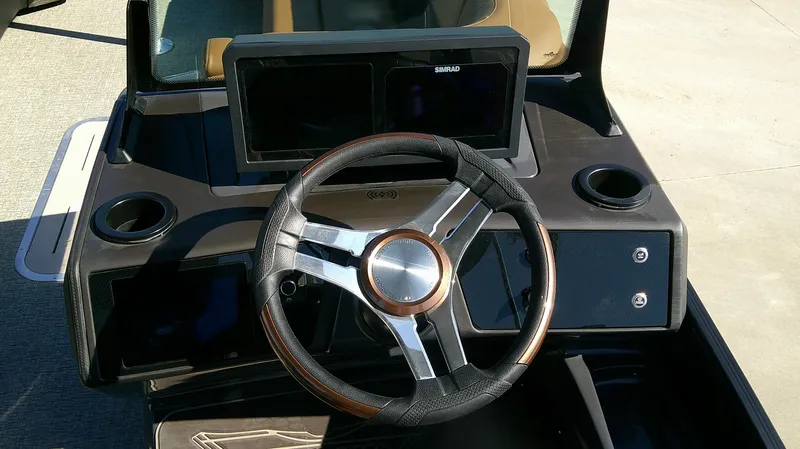 Slide: The Image of 2025 Bennington MFB 26 boat dashboard with steering wheel and digital display. - 8