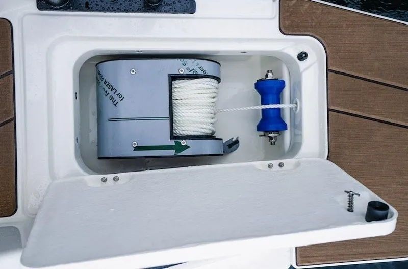 Slide: The Image of Navan C30 2025 boat compartment with rope storage and blue roller. - 14
