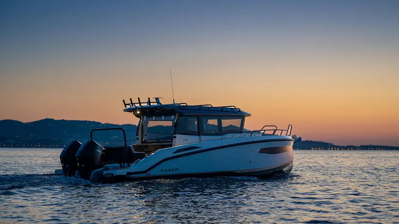 Slide: The Image of Navan C30 2025 boat cruising at sunset on calm waters. - 16