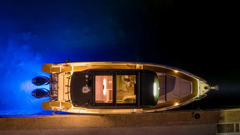 Slide: The Image of Top view of 2025 Navan C30 boat with blue underwater lights at night. - 19