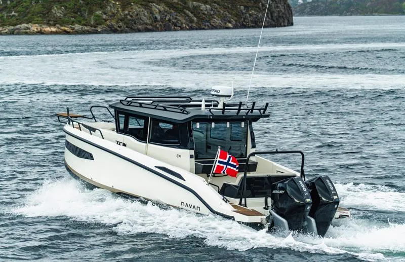 Slide: The Image of Navan C30 2025 boat cruising on water with Norwegian flag. - 22