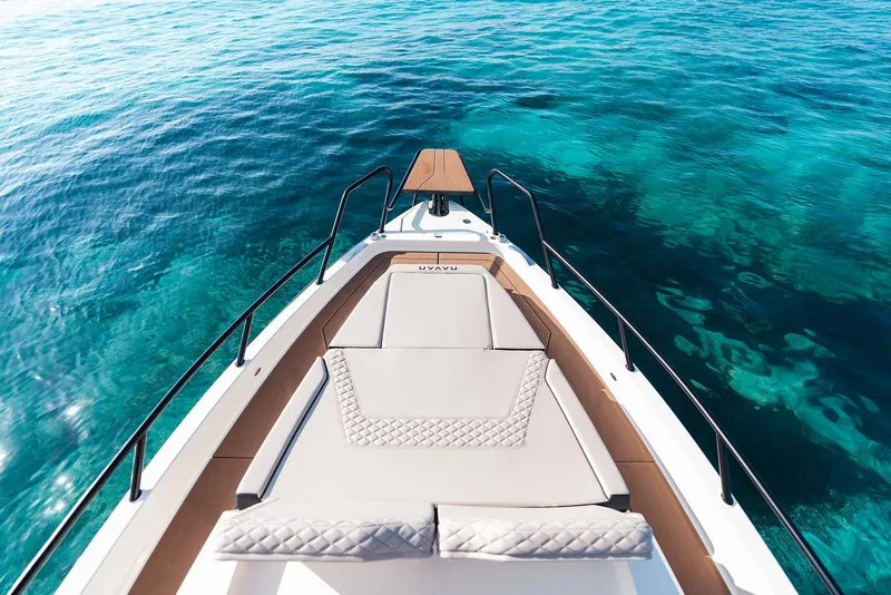 Slide: The Image of Navan C30 boat on clear blue water, showcasing luxury deck design, 2025 model. - 8