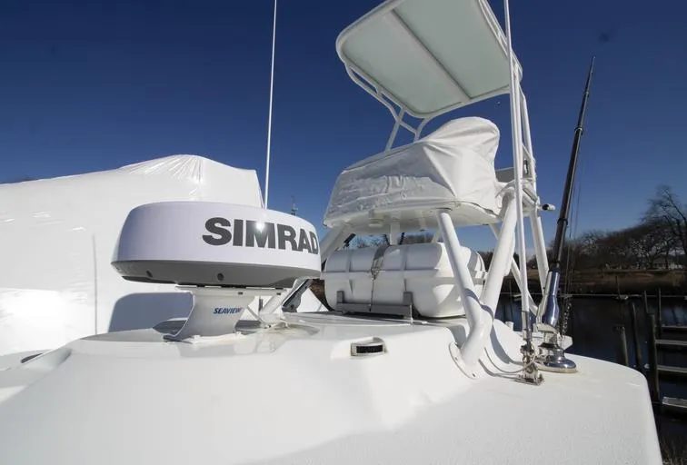 Slide: The Image of 2018 Yellowfin 36 boat with Simrad radar, white seating, and clear blue sky. - 13