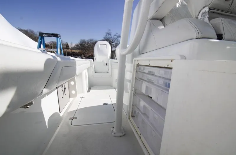 Slide: The Image of 2018 Yellowfin 36 boat interior with white seating and storage compartments. - 14