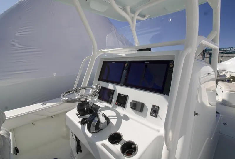Slide: The Image of 2018 Yellowfin 36 boat console with dual screens and steering wheel. - 18
