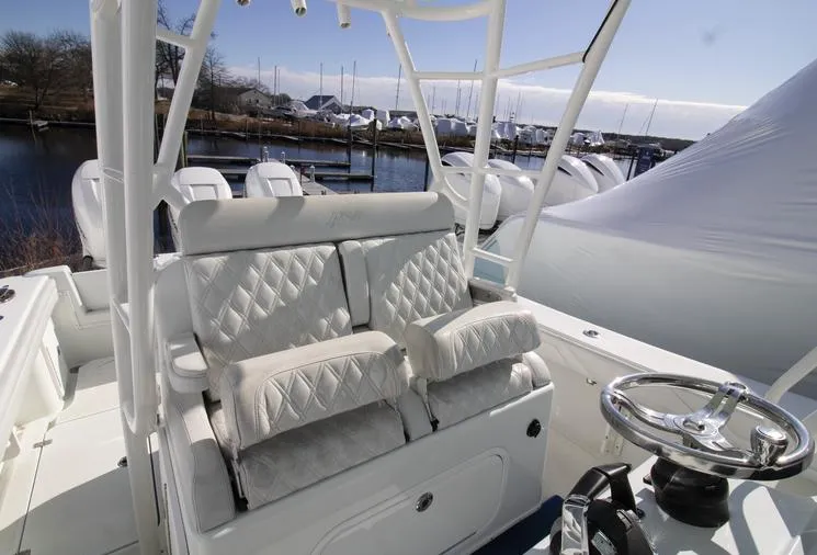 Slide: The Image of 2018 Yellowfin 36 boat interior with white cushioned seating and steering wheel. - 19