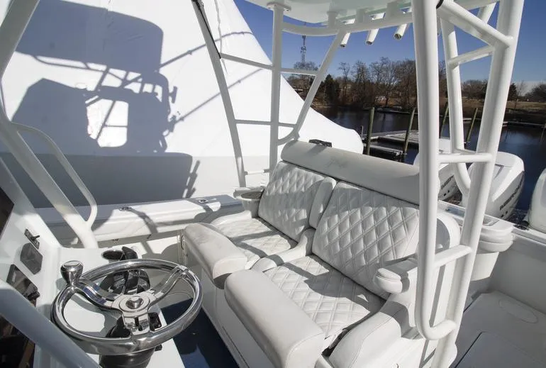 Slide: The Image of 2018 Yellowfin 36 boat interior with white seating and steering wheel. - 3