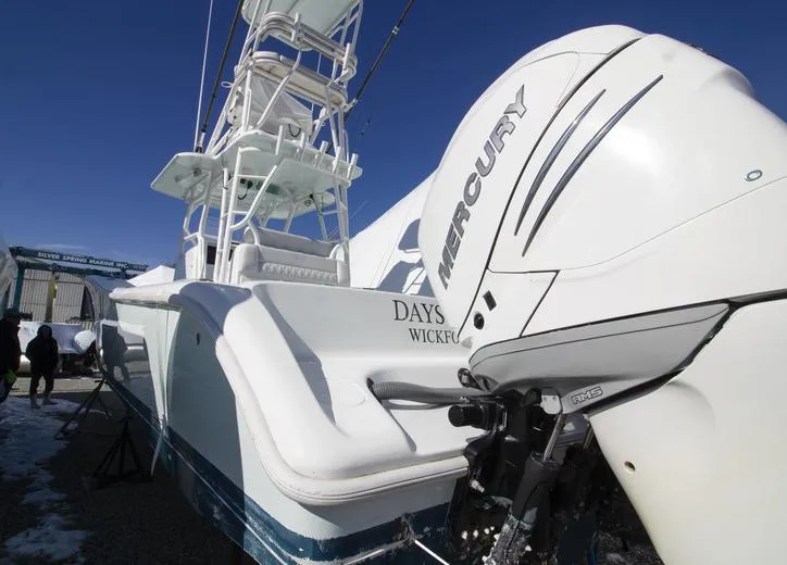 Slide: The Image of 2018 Yellowfin 36 boat with Mercury outboard engine, docked under clear blue sky. - 4